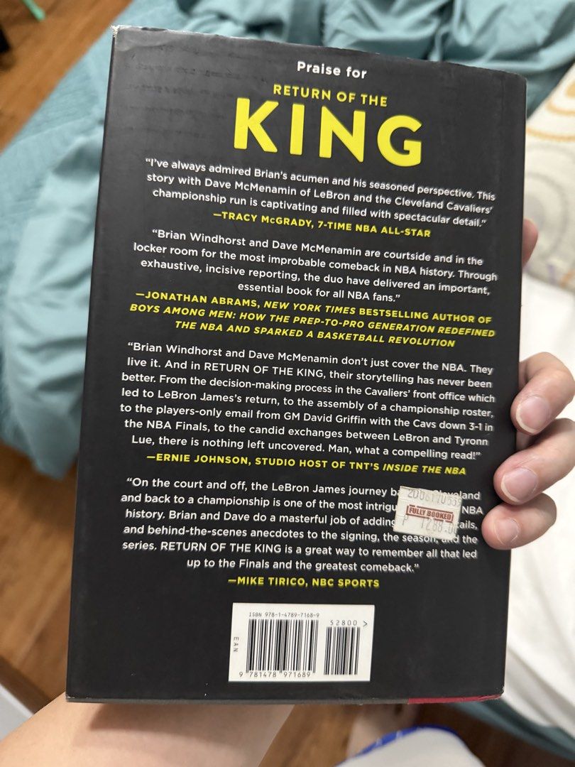 Return of the King: LeBron James Book (Category: Storybooks) located in Pasig City. Submitted by aids888 (Listing ID 1438465733, Image 2). Description: - "Return of the King" book about LeBron James and the Cleveland Cavaliers' NBA comeback. - Authored by Brian Windhorst and Dave McMenamin. - Includes quotes from Tracy McGrady and Ernie Johnson. - Features a barcode on the back cover. - Includes a sticker on the back cover..