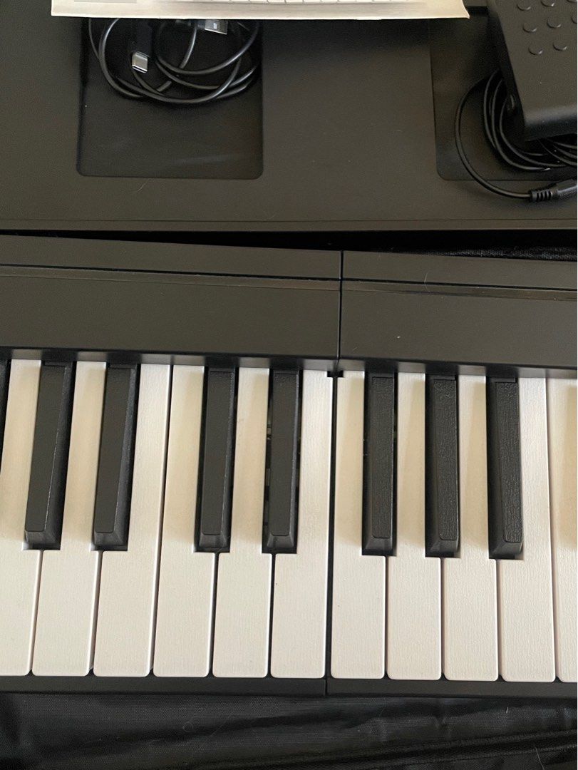 Rixton Foldable Piano (Category: Musical Instruments) located in Manila. Submitted by epicriver-b00d (Listing ID 1438324066, Image 2). Description: A foldable piano with bluetooth functions. brand: Rixton Comes with: Case Sustain pedal Manual Note Sheet stand (with The battery runs out fast, so use it while charging.).