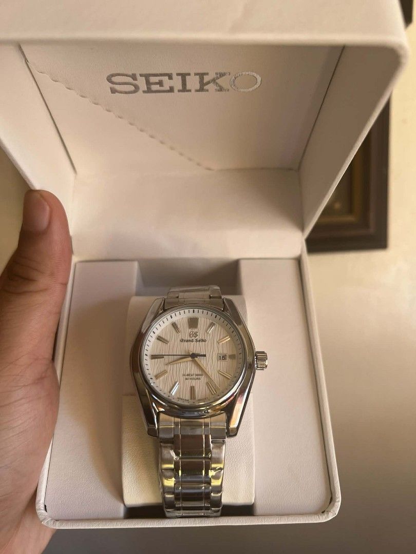 Seiko Grand Seiko Watch (Category: Luxury Watches) located in Manila. Submitted by danielekurt_ (Listing ID 1438477515, Image 2). Description: - Grand Seiko watch - Silver stainless steel bracelet - White dial - Includes box, paper bag, and watch case - Date display - Textured dial.