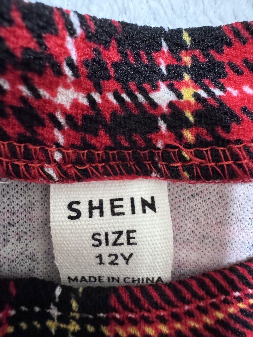 SHEIN Red Plaid Dress - Size 12Y (Category: Dresses) located in Mandaluyong City. Submitted by toront0427 (Listing ID 1438433417, Image 3). Description: - Red plaid pattern - Long sleeves - Ruffle details on shoulders - Gathered waist - Made in China.