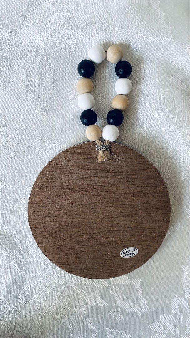 S'mores Wall Decor with Beads (Category: Wall Decor) located in Quezon City. Submitted by smithram (Listing ID 1438323941, Image 3). Description: Wall decor features a round wooden design with the words "I love you S'more" and a s'mores graphic. It has a black frame and a string of beads for hanging. The back of the decor has a wooden finish and a "Made in China" sticker..