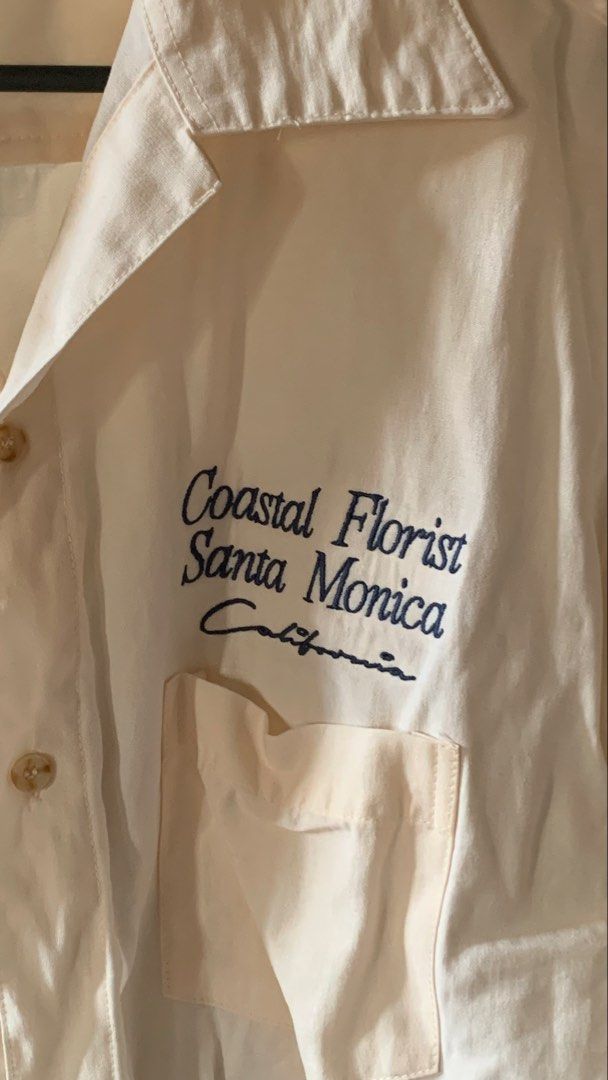 Smyth Coastal Florist Shirt (Category: Tshirts & Polo Shirts ) located in Quezon City. Submitted by gofundgill (Listing ID 1438427336, Image 3). Description: - Cream-colored Smyth shirt - Floral design on the back - "Coastal Florist Santa Monica California" embroidery on the front - Short sleeves - Button-down closure - Chest pocket.