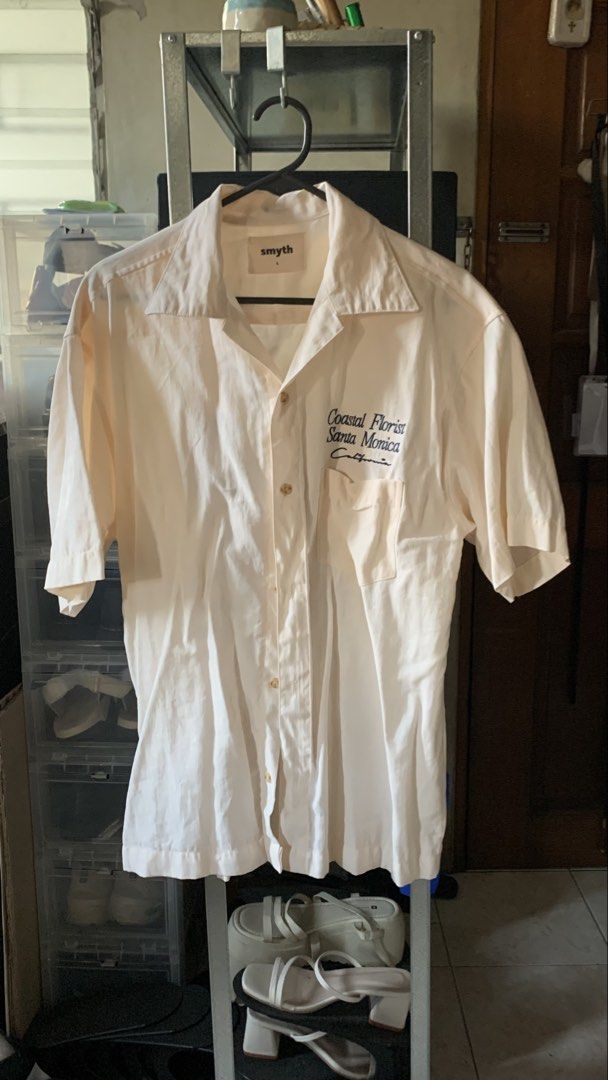 Smyth Coastal Florist Shirt (Category: Tshirts & Polo Shirts ) located in Quezon City. Submitted by gofundgill (Listing ID 1438427336, Image 1). Description: - Cream-colored Smyth shirt - Floral design on the back - "Coastal Florist Santa Monica California" embroidery on the front - Short sleeves - Button-down closure - Chest pocket.