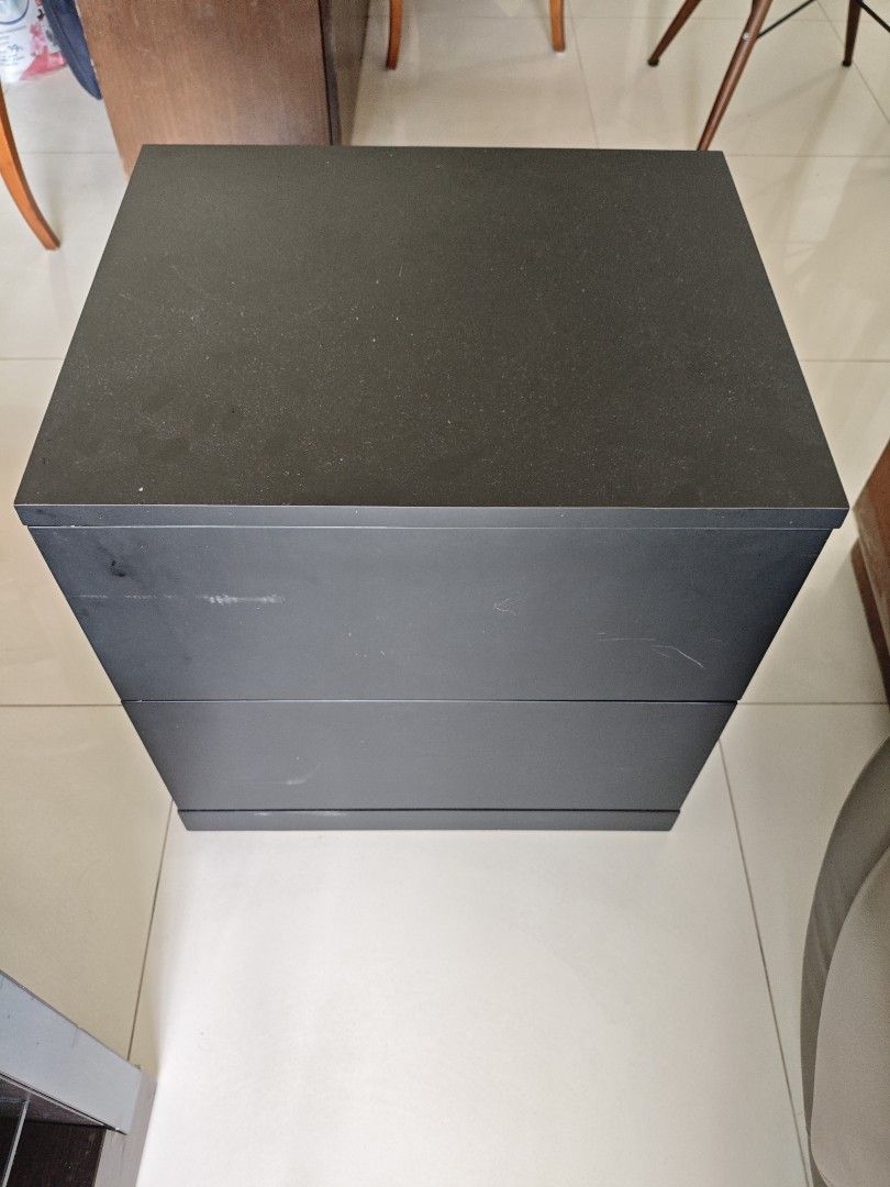 Solid Wood Bedside Table (Category: Tables & Sets) located in Singapore. Submitted by lilyy6_ (Listing ID 1438401877, Image 1). Description: - solid wood (heavy & robust) - dimensions in cm: 50 width x 42 depth 57 height - Stylish black nightstand - Two drawers for storage - Suitable for bedrooms or living rooms - Drawers slide smoothly - Good condition with minor wear and tear.