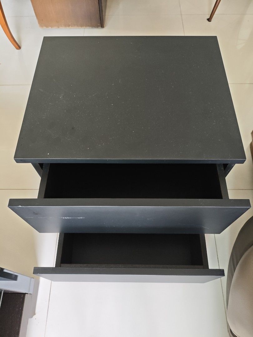 Solid Wood Bedside Table (Category: Tables & Sets) located in Singapore. Submitted by lilyy6_ (Listing ID 1438401877, Image 2). Description: - solid wood (heavy & robust) - dimensions in cm: 50 width x 42 depth 57 height - Stylish black nightstand - Two drawers for storage - Suitable for bedrooms or living rooms - Drawers slide smoothly - Good condition with minor wear and tear.