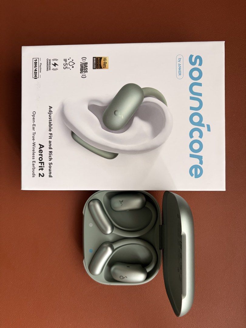 Soundcore AeroFit 2 Open-Ear Wireless Earbuds - Green (Category: Earphones) located in Singapore. Submitted by greenapplepie (Listing ID 1438413991, Image 1). Description: Soundcore AeroFit 2 earbuds in green and like-new condition (use it less than 5 times), doesn’t suit to my liking. Features include open-ear design, wireless charging, and IP55 water resistance. Enjoy up to 10 hours of playtime. Comes with the original box..