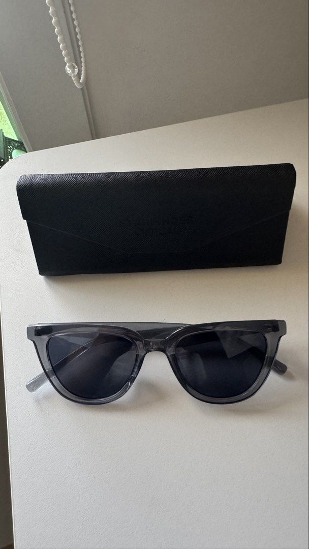 Starfinder Optical Grey/Black Sunglasses (Category: Sunglasses & Eyewear) located in Paranaque City. Submitted by migvee (Listing ID 1438380612, Image 1). Description: - Starfinder Optical sunglasses - Sleek, dark frame and lenses - Modern design for everyday wear - Includes a black protective case - Case features embossed brand name.