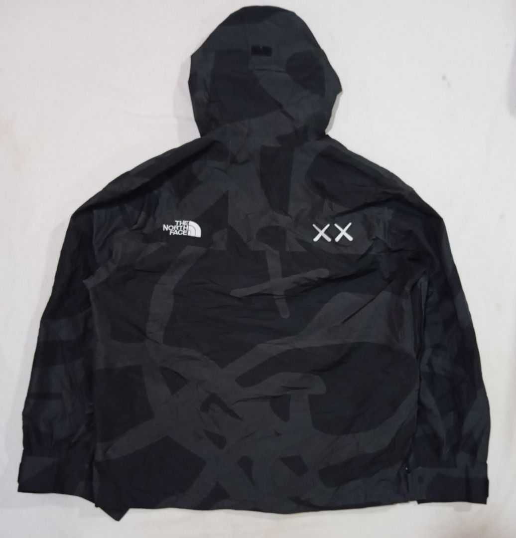 KAWS x The North Face Retro 1986 Mountain Jacket (Category: Coats, Jackets and Outerwear) located in Cagayan de Oro. Submitted by hustlefinds (Listing ID 1438355378, Image 2). Description: KAWS x The North Face Retro 1986 Mountain Jacket in black featuring an abstract camouflage pattern. Brand new condition.
