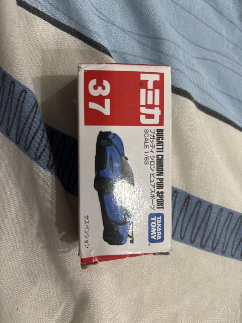Tomica Bugatti Chiron Pur Sport (Category: Vehicle & Diecast Models) located in Manila. Submitted by colin92421 (Listing ID 1438476825, Image 1). Description: - Tomica No. 37 Bugatti Chiron Pur Sport - Scale: 1/63 - Color: Blue with black accents - Includes original box - Features detailed design - Bugatti logo present - Perfect for car enthusiasts and collectors.