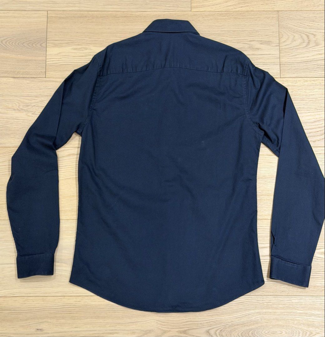 Topman Slim Fit Navy Button up Shirt (Category: Tshirts & Polo Shirts ) located in Quezon City. Submitted by joes3 (Listing ID 1438393055, Image 2). Description: Topman Slim Fit Button Down Shirt - Color: Navy blue - Features: Button-down front, long sleeves, chest logo - Size: UK XS (fits 34-36 inch chest) - measurements in the photo Great for Formal events or Office wear Steal Price!! Never Used .