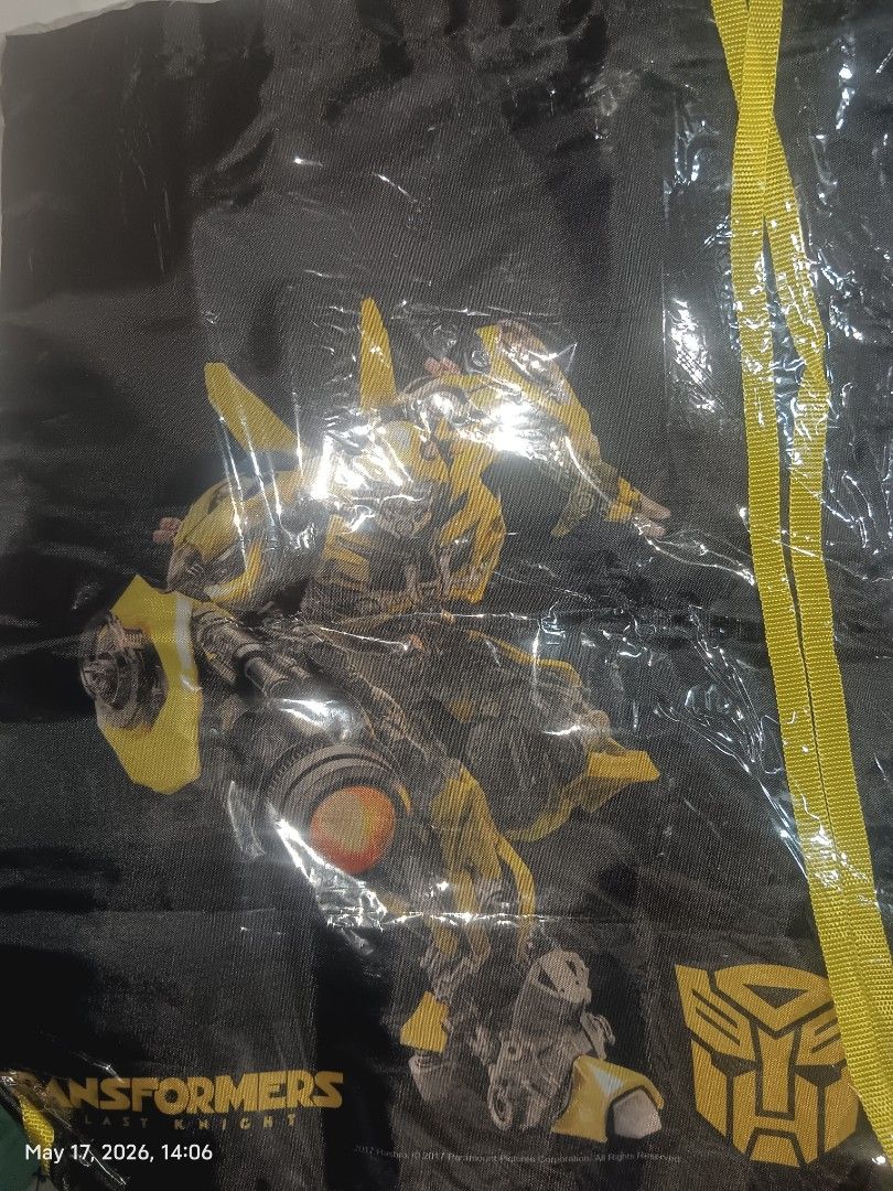 Transformers: The Last Knight 7-Eleven Promo String Bag (Category: Western Merchandise) located in Caloocan City. Submitted by td21collector (Listing ID 1438360221, Image 2). Description: - Transformers themed string bag - Features Bumblebee (black bag) and Optimus Prime (blue bag) - Movie Promotional item.