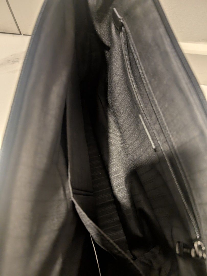 Tumi Black Briefcase Laptop bag with Shoulder Strap (Category: Briefcases) located in Manila. Submitted by seanapaul (Listing ID 1438426103, Image 2). Description: - Black Tumi briefcase - Includes a detachable shoulder strap with padded rest - Multiple interior compartments - Secure zip closure - Comfortable leather handle - Authentic Tumi tag - Striped interior lining - Compartment to open and fix onto carry on luggage .