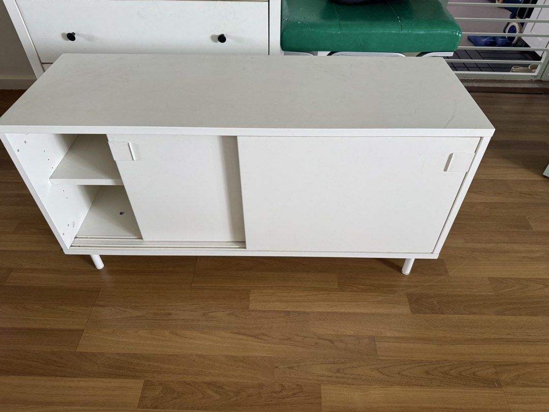 tv console (Category: Shelves, Cabinets & Racks) located in Singapore. Submitted by littlekidz (Listing ID 1438357708, Image 1). Description: - White sideboard - Sliding door - Internal shelf for storage - Minor signs of use - Includes legs - Suitable for living rooms or bedrooms 1.2m x 50cm x 60cm.