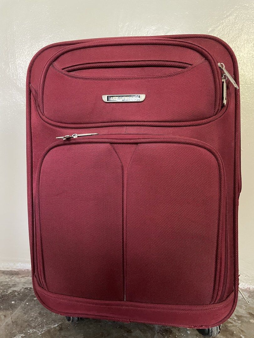 Urban Luggage Maroon Suitcase (Category: Luggage) located in Santa Rosa. Submitted by emelyn71 (Listing ID 1438383111, Image 1). Description: - Maroon Urban luggage - Multiple compartments - TSA lock for security - Retractable handle and wheels for easy transport - Interior straps to secure belongings - Front pocket for quick access - Top handle for carrying - Patterned interior lining - Visible zippers.