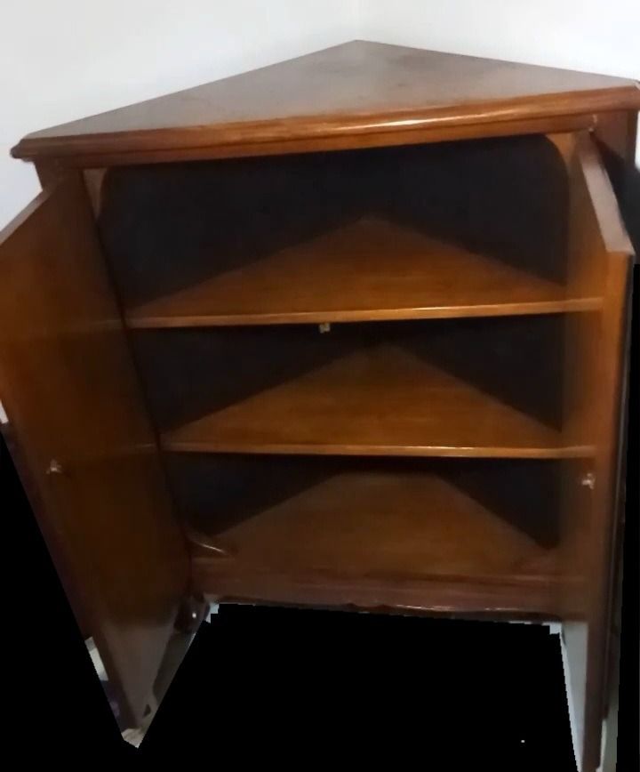 Vintage 1980's Narra "Triangular" Cabinet with Shelves (Category: Shelves, Cabinets & Racks) located in Pasig City. Submitted by clevermountain.cfe94d (Listing ID 1438449286, Image 2). Description: - "Uniquely-designed Triangular" corner cabinet (made of Narra wood) - Two doors (made of Narra wood) with decorative carvings - Three (3) interior shelves - Space-saving corner design - Classic and versatile style.