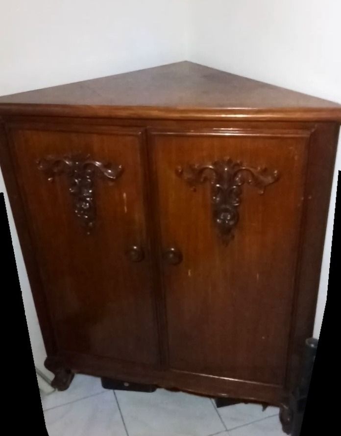 Vintage 1980's Narra "Triangular" Cabinet with Shelves (Category: Shelves, Cabinets & Racks) located in Pasig City. Submitted by clevermountain.cfe94d (Listing ID 1438449286, Image 1). Description: - "Uniquely-designed Triangular" corner cabinet (made of Narra wood) - Two doors (made of Narra wood) with decorative carvings - Three (3) interior shelves - Space-saving corner design - Classic and versatile style.
