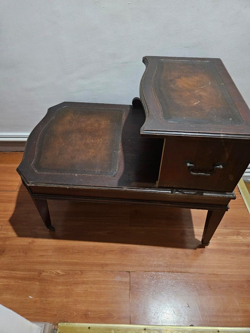 Vintage Wooden Side Table with Drawer (Category: Tables & Sets) located in Caloocan City. Submitted by rm.diaz (Listing ID 1438436900, Image 1). Description: - Vintage side table - Features a drawer with metal handle - Dark wooden finish - Decorative edges - Sturdy and functional - Stylish design.
