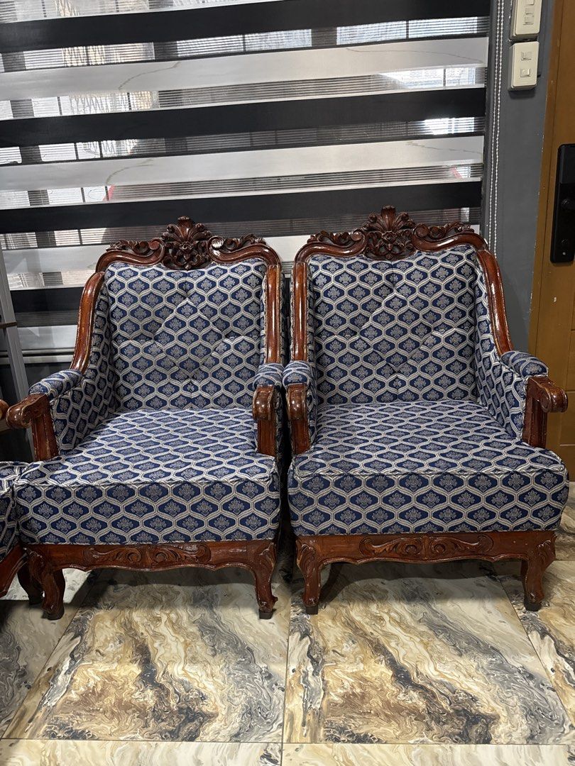 Vintage Wooden Sofa with Patterned Upholstery (Category: Sofas) located in Manila. Submitted by letsirkrom34542 (Listing ID 1438387568, Image 2). Description: - Vintage sofa - Intricate wooden detailing - Patterned upholstery - Classic design - Comfortable seating - Adds vintage charm Selling one set of wooden with foam sofa color blue, design as per picture. Wet and dry cleaning at foam and re-varnish of wooden part done last month. Sophisticate