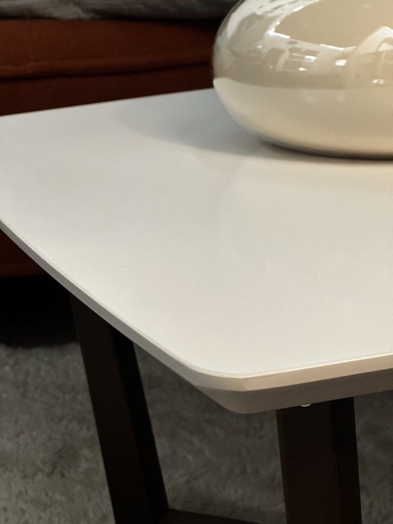 White Square Coffee Table with Wooden Legs (Edward Coffee Table) (Category: Tables & Sets) located in Caloocan City. Submitted by toniluigi515 (Listing ID 1438494868, Image 3). Description: Minimalist and modern coffee table with a clean white top and sturdy dark wood base. Perfect for small living spaces, condos, or as an accent/end table. Stylish, functional, and easy to match with any interior. Original Price: ₱9,000 (bought at CW Home Depot) 