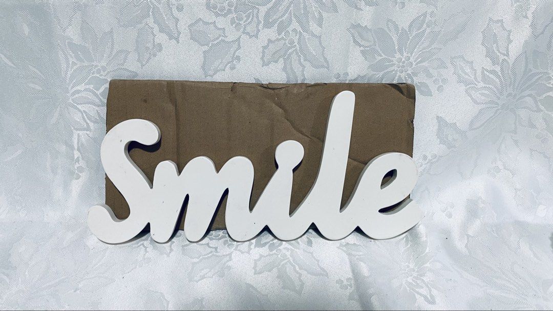 White wooden "Smile" wall decor (Category: Wall Decor) located in Quezon City. Submitted by smithram (Listing ID 1438329483, Image 1). Description: Wooden white "Smile" wall decor with ready metal wall hanger at the back. .