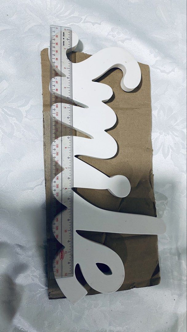White wooden "Smile" wall decor (Category: Wall Decor) located in Quezon City. Submitted by smithram (Listing ID 1438329483, Image 3). Description: Wooden white "Smile" wall decor with ready metal wall hanger at the back. .