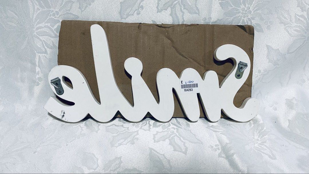White wooden "Smile" wall decor (Category: Wall Decor) located in Quezon City. Submitted by smithram (Listing ID 1438329483, Image 2). Description: Wooden white "Smile" wall decor with ready metal wall hanger at the back. .
