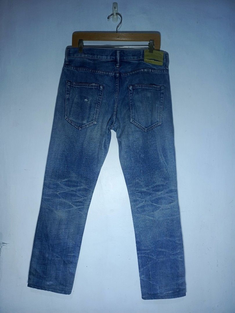 WTAPS DISTRESSED DENIM JEANS (Category: Jeans) located in Baguio. Submitted by 074thriftmania (Listing ID 1438424474, Image 2). Description: - Authentic WTAPS denim jeans - Classic five-pocket design - Button fly - Distressed look with tear on front - Leather patch on back - Straight leg cut - Faded blue color waistline 32-34" length 39" 980+sf.