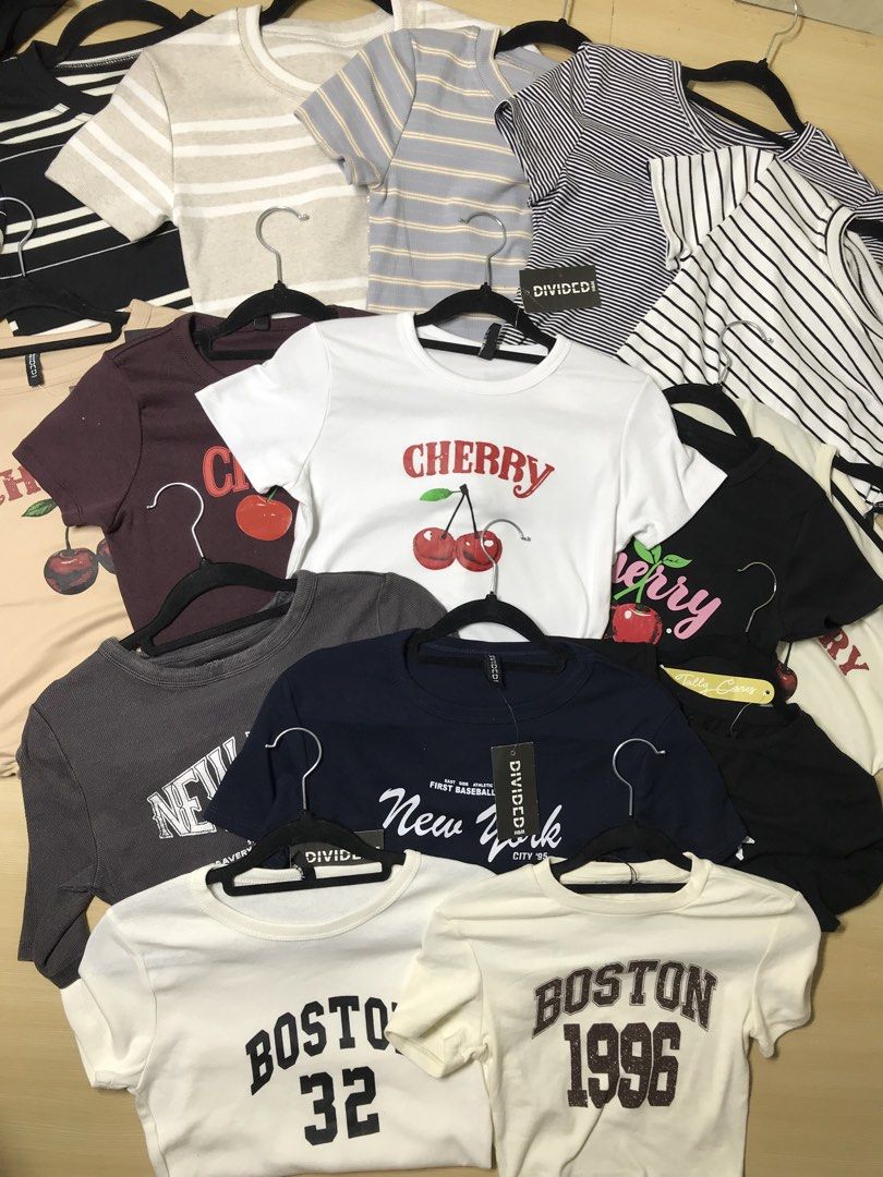 Y2k overruns croptop assorted items (Category: Shirts) located in Navotas City. Submitted by jericafits (Listing ID 1438478193, Image 2). Description: Collection of various graphic t-shirts. Includes brands like Adidas, Calvin Klein Jeans, Bershka, and H&M. Features designs with text, logos, and graphics. Available in multiple colors and styles. Some shirts have tags attached..