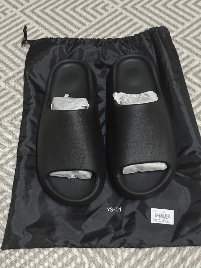 YEEZY Slide YS-01 Black 10/11 US (Category: Slippers & Slides) located in Quezon City. Submitted by justthinkingg (Listing ID 1438398803, Image 2). Description: For sale - YEEZY Slide YS-01 Black BRAND NEW❗️ On hand - 5.5k each Size 10US Size 11US Buyer shoulders delivery fee Location: Sta Mesa, QC Complete with dust bag Follow us at IG: apex.hype.