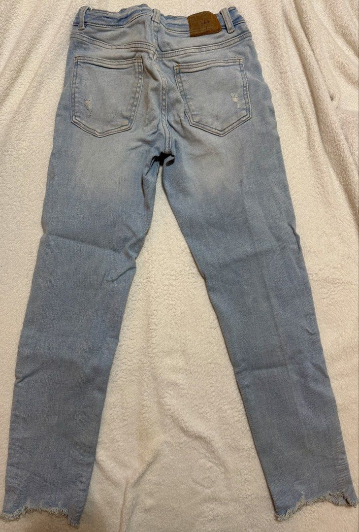 Zara Distressed Jeans Size 11-12 (Category: Jeans) located in Mandaluyong City. Submitted by toront0427 (Listing ID 1438473266, Image 2). Description: - Zara light wash jeans - Distressed details - Button and zipper closure - Straight leg cut - Raw hem - Size 11-12 - Made in Bangladesh - Perfect for everyday wear.