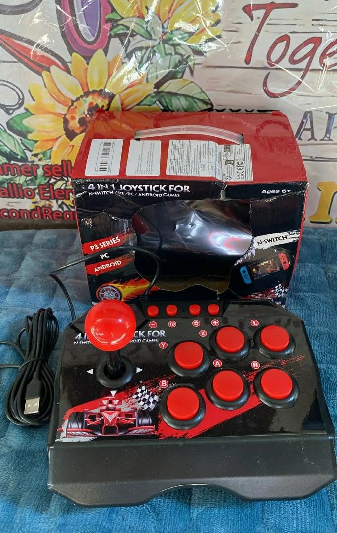 4-in-1 Joystick for PS3/PC/Android/Switch (Category: Controllers) located in Taguig. Submitted by jerafelsan87737 (Listing ID 1438678895, Image 1). Description: - Compatible with PS3, PC, Android, and Nintendo Switch - Features a racing car design - Red joystick and buttons with a black base - USB cable included - Suitable for ages 6+.