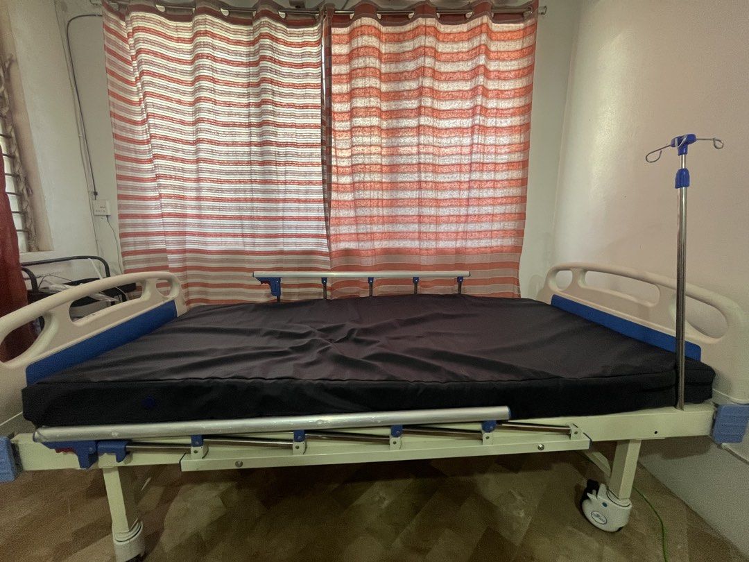 Adjustable Hospital Bed with IV Stand (Category: Medical Supplies & Tools) located in Consolacion. Submitted by claustings (Listing ID 1438658659, Image 1). Description: - Adjustable hospital bed - Includes comfortable mattress and integrated IV stand - Adjustable height and backrest via cranks - Equipped with wheels for easy mobility - Sturdy frame, well-maintained condition - Ideal for home or clinical settings - Slightly nego!! no to lowballer