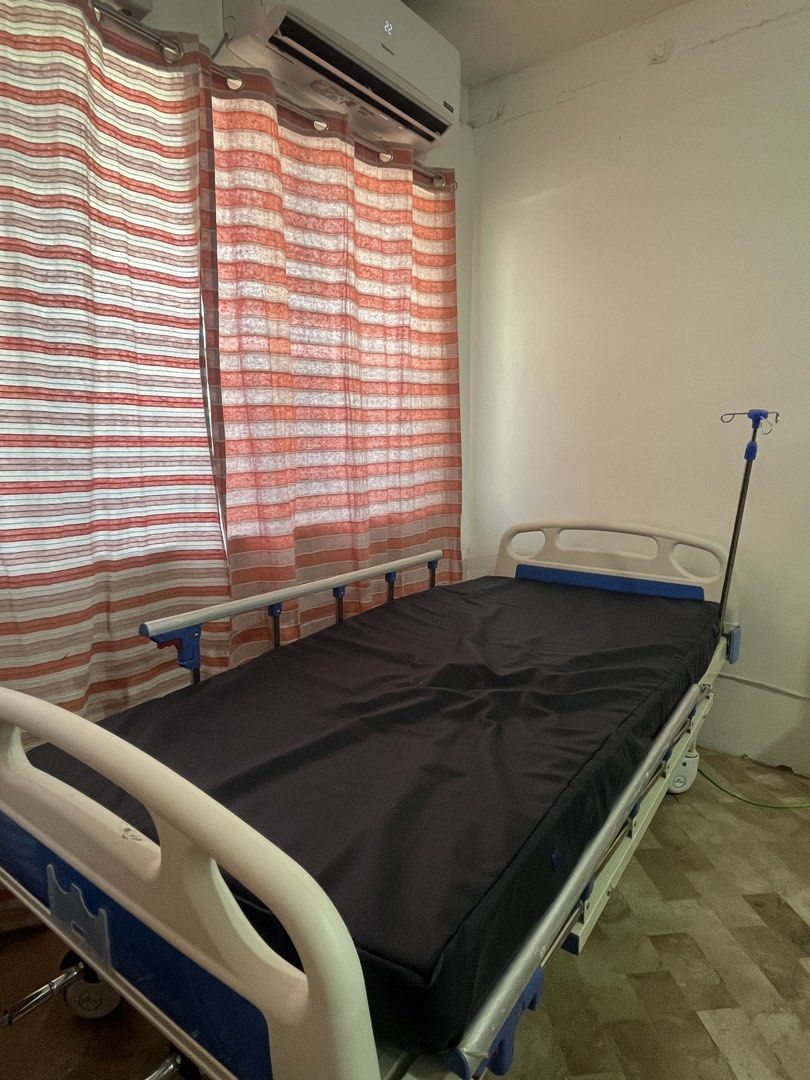 Adjustable Hospital Bed with IV Stand (Category: Medical Supplies & Tools) located in Consolacion. Submitted by claustings (Listing ID 1438658659, Image 2). Description: - Adjustable hospital bed - Includes comfortable mattress and integrated IV stand - Adjustable height and backrest via cranks - Equipped with wheels for easy mobility - Sturdy frame, well-maintained condition - Ideal for home or clinical settings - Slightly nego!! no to lowballer