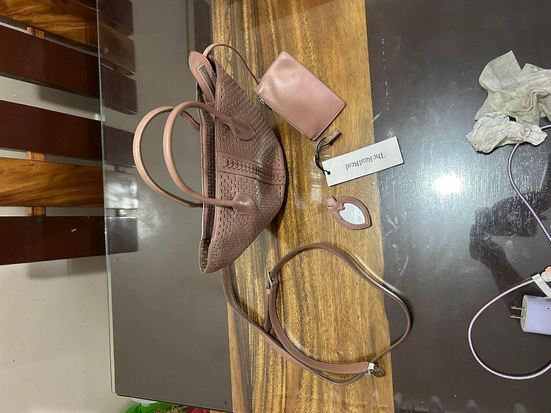 Authentic Alaïa Eyelet Leather Handle Bag (Pre-owned) (Category: Luxury Bags & Wallets) located in Taguig. Submitted by jjcollectivefinds (Listing ID 1438686621, Image 3). Description: please note there is noticeable wear/tearing on the leather loop connecting the strap hardware (see photos) ​.