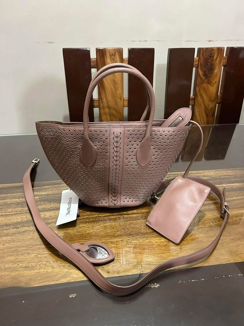 Authentic Alaïa Eyelet Leather Handle Bag (Pre-owned) (Category: Luxury Bags & Wallets) located in Taguig. Submitted by jjcollectivefinds (Listing ID 1438686621, Image 1). Description: please note there is noticeable wear/tearing on the leather loop connecting the strap hardware (see photos) ​.