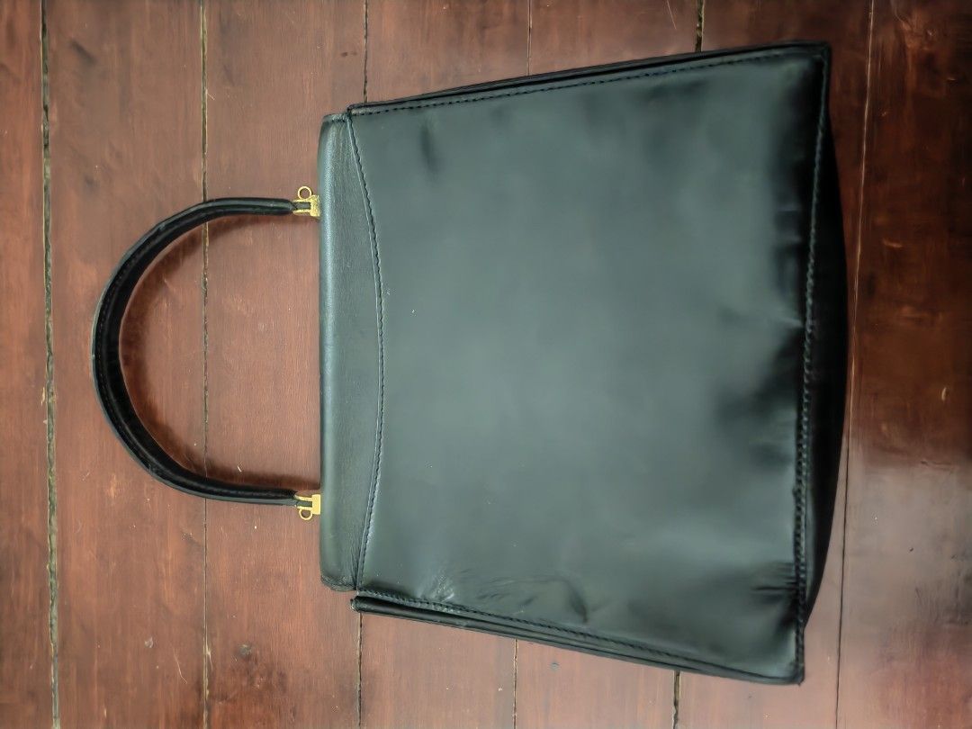 Bally Black Handbag (Category: Luxury Bags & Wallets) located in Makati City. Submitted by brooklyn87370 (Listing ID 1438540333, Image 2). Description: - Bally black handbag - Top handle design - Features a flap closure - Gold-toned logo detail - Interior zipper pocket - Crafted from leather - A classic and versatile accessory.