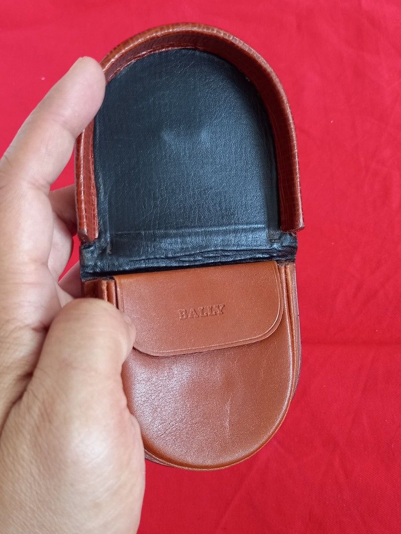 Bally Leather Coin Purse (Category: Wallets & Card holders) located in Tuguegarao City. Submitted by zenphoenix-7ad615 (Listing ID 1438576214, Image 3). Description: - Authentic Bally coin purse - Brown textured leather exterior - Gold-colored Bally logo - Interior: Black and brown leather lining - Features a small pocket - Marked "Made in Italy".