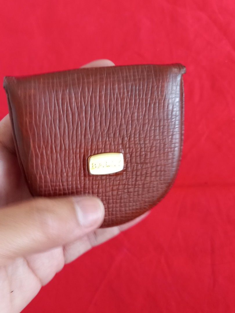 Bally Leather Coin Purse (Category: Wallets & Card holders) located in Tuguegarao City. Submitted by zenphoenix-7ad615 (Listing ID 1438576214, Image 2). Description: - Authentic Bally coin purse - Brown textured leather exterior - Gold-colored Bally logo - Interior: Black and brown leather lining - Features a small pocket - Marked "Made in Italy".