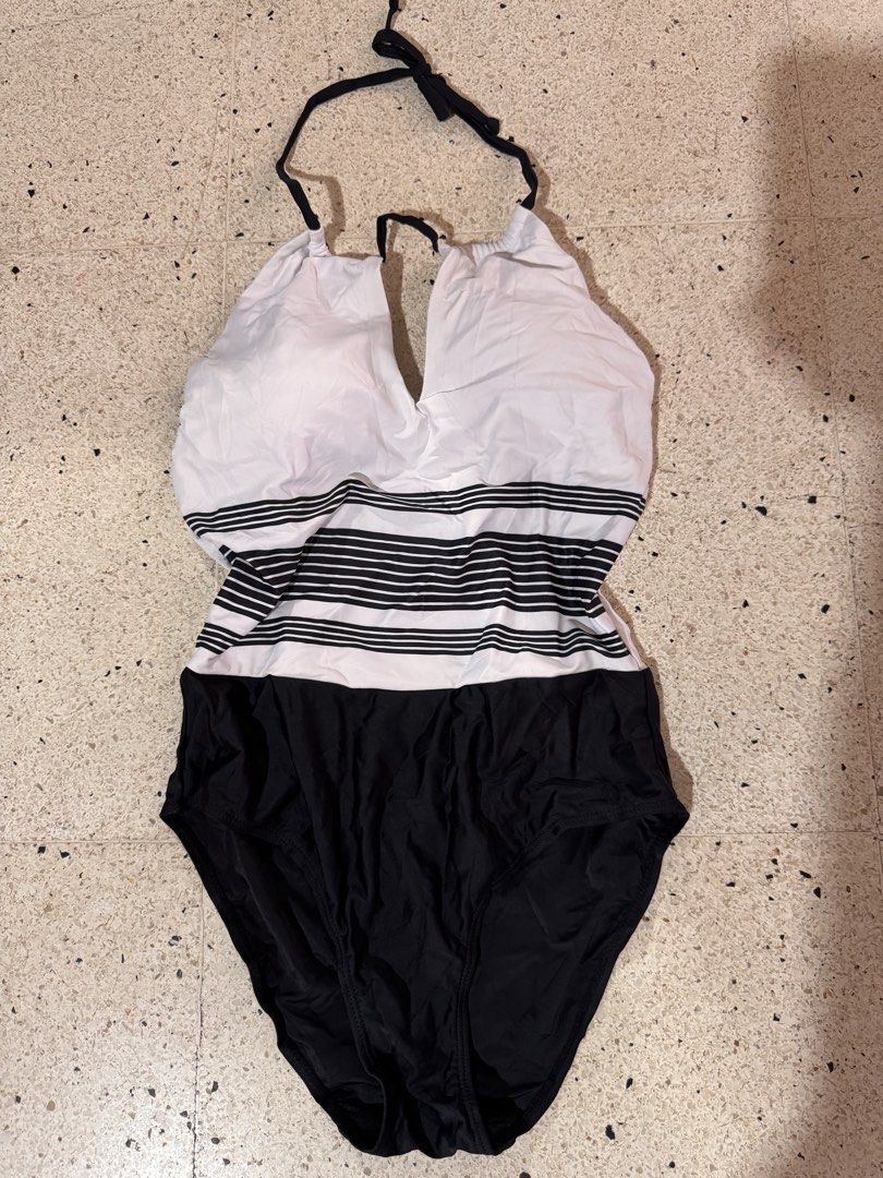 Black and White Halter Swimsuit (Category: Bikinis & Swimsuits) located in Marikina City. Submitted by 1stuffshop (Listing ID 1438512353, Image 1). Description: - Halter neck design - One-piece swimsuit - Top: White with black horizontal stripes - Bottom: Black - V-neckline - Material: Smooth, possibly synthetic fabric UNUSED .