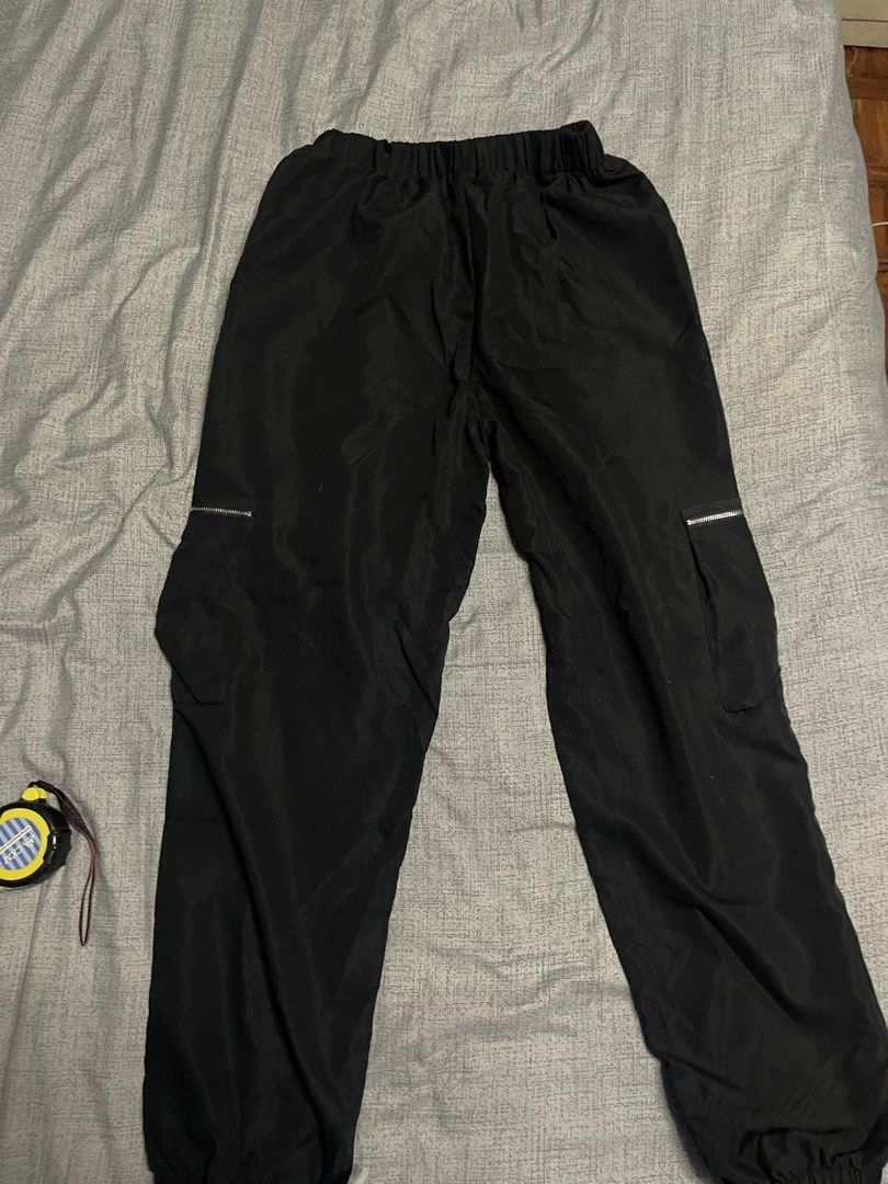 Lightweight Black Cargo Pants (Category: Other Bottoms) located in Quezon City. Submitted by listless32 (Listing ID 1438690670, Image 2). Description: Waist 24 to 32 L 38 Black cargo pants with elastic waist and ankle cuffs. Features zippered side pockets and a relaxed fit. Lightweight fabric..