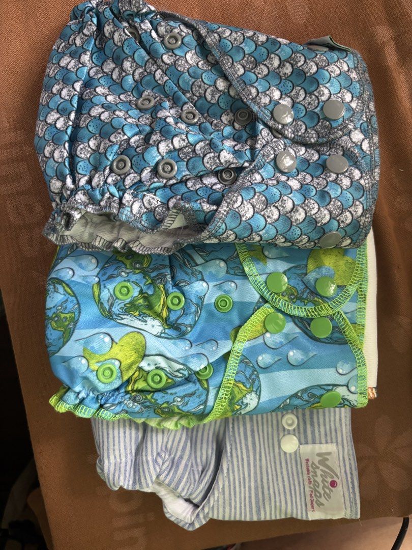 Bnew Cloth Diapers EcoBum and White Snaps (Category: Diapers & Baby Wipes) located in Antipolo. Submitted by seylecious (Listing ID 1438526884, Image 1). Description: - pack of 3 bnew cloth diaper set - Includes 2 inserts and various designs: - Blue and white scale pattern - Blue and green earth pattern - Blue stripes white pattern - Snap closures for easy adjustment - Diapers are in good, ready-to-use condition .
