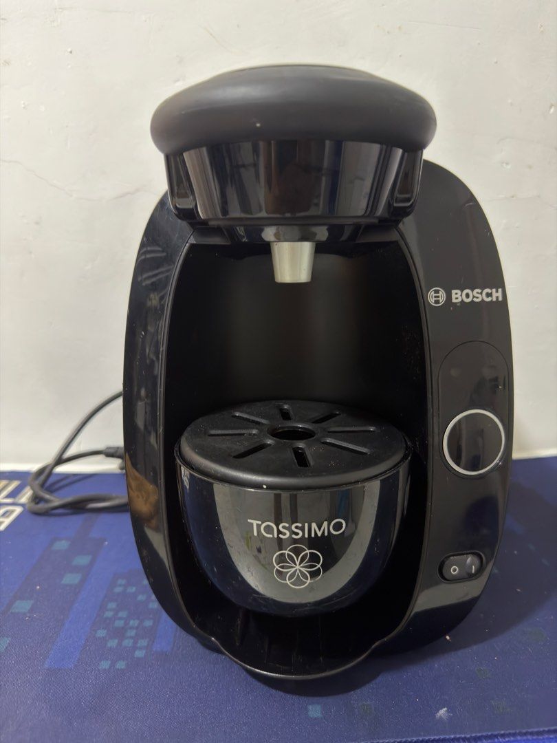 Bosch Tassimo Coffee Machine (Category: Coffee Machines & Makers) located in Trece Martires City. Submitted by raresen26 (Listing ID 1438585649, Image 1). Description: - Black Bosch Tassimo coffee machine - Includes water tank and manual - Model: TAS 20xx - Features power button and Tassimo logo - Clear water tank with max fill line - good as new - with box and manual.