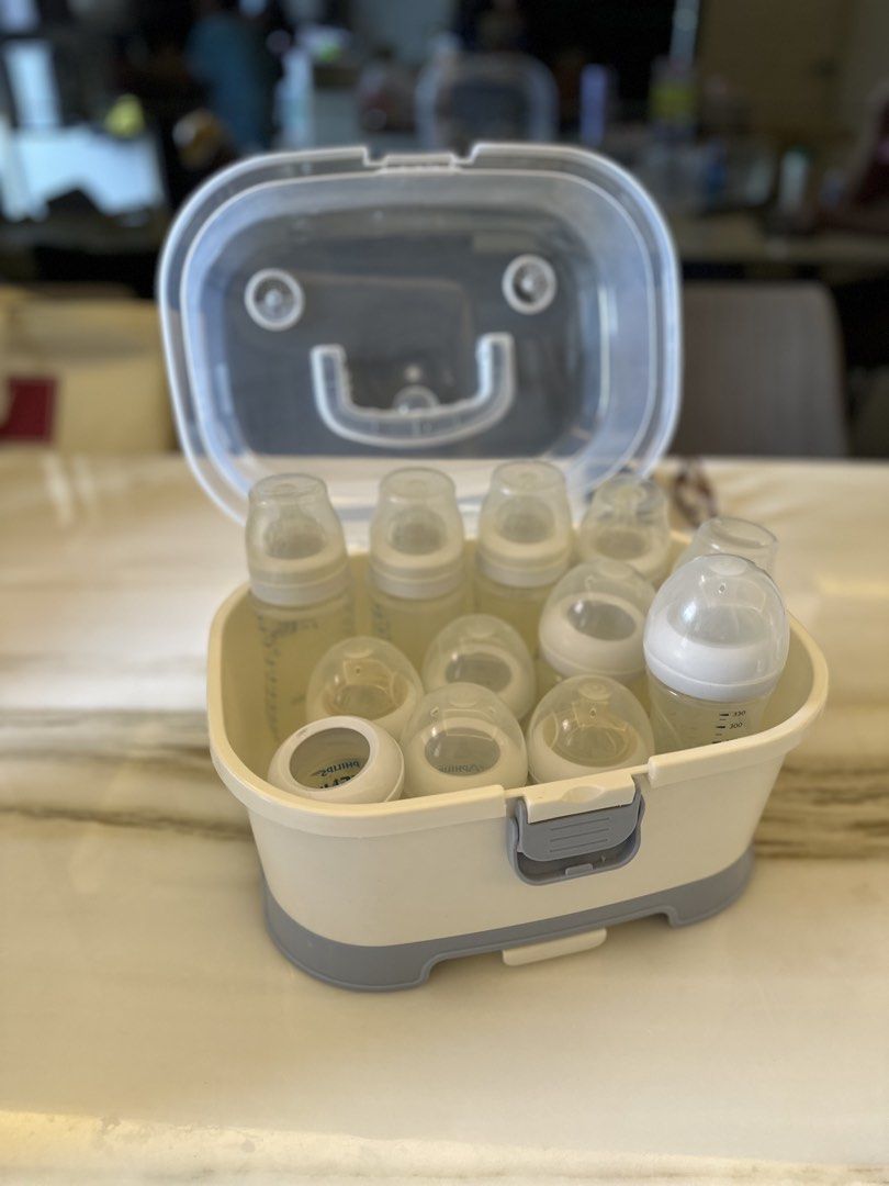 Bottles and storage box (Category: Breastfeeding & Bottle Feeding) located in Quezon City. Submitted by happysissies (Listing ID 1438515540, Image 2). Description: - Baby bottles and accessories. - Clear lid for easy viewing. - Features a secure latch. - Includes a tray for organized bottle placement. - Stylish white and gray design. - Easy to use and clean. -Negotiable!.