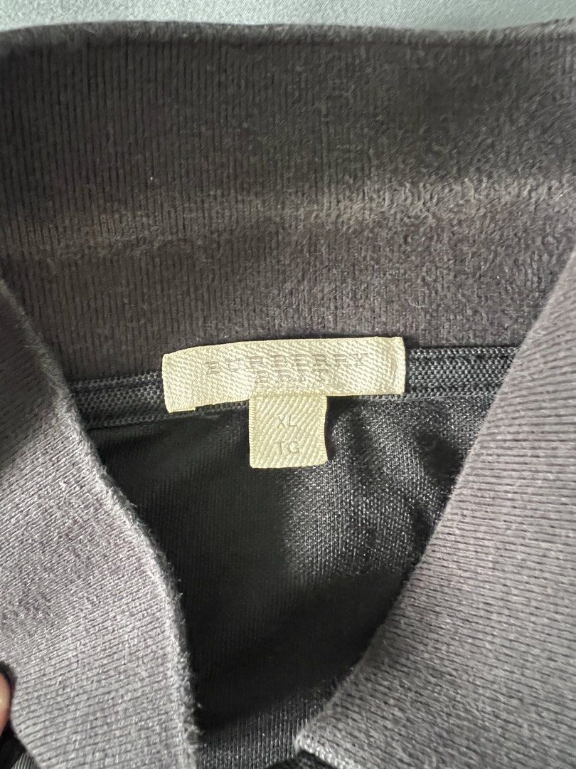 Burberry Polo Shirt - XL (Category: Tshirts & Polo Shirts ) located in Manila. Submitted by puffsxbangs (Listing ID 1438558794, Image 2). Description: - Authentic Burberry polo shirt - Color: Black - Size: XL - Classic polo collar and short sleeves - Embroidered Burberry logo Issue: seen in pics W:21 inches L: 26 inches.