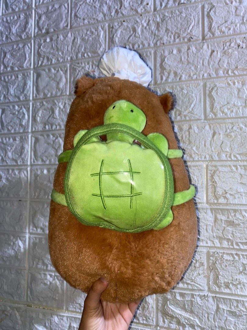 Capybara Plush Toy with Chef Hat (Category: Toys & Games) located in Manila. Submitted by jb_alvarez1 (Listing ID 1438651353, Image 3). Description: - Adorable capybara plush toy - Features a chef's hat - Comes with a green backpack with a turtle design - Brown with dark brown face, paws, and feet - Cuddly and perfect for gifting or collecting -34 cm.