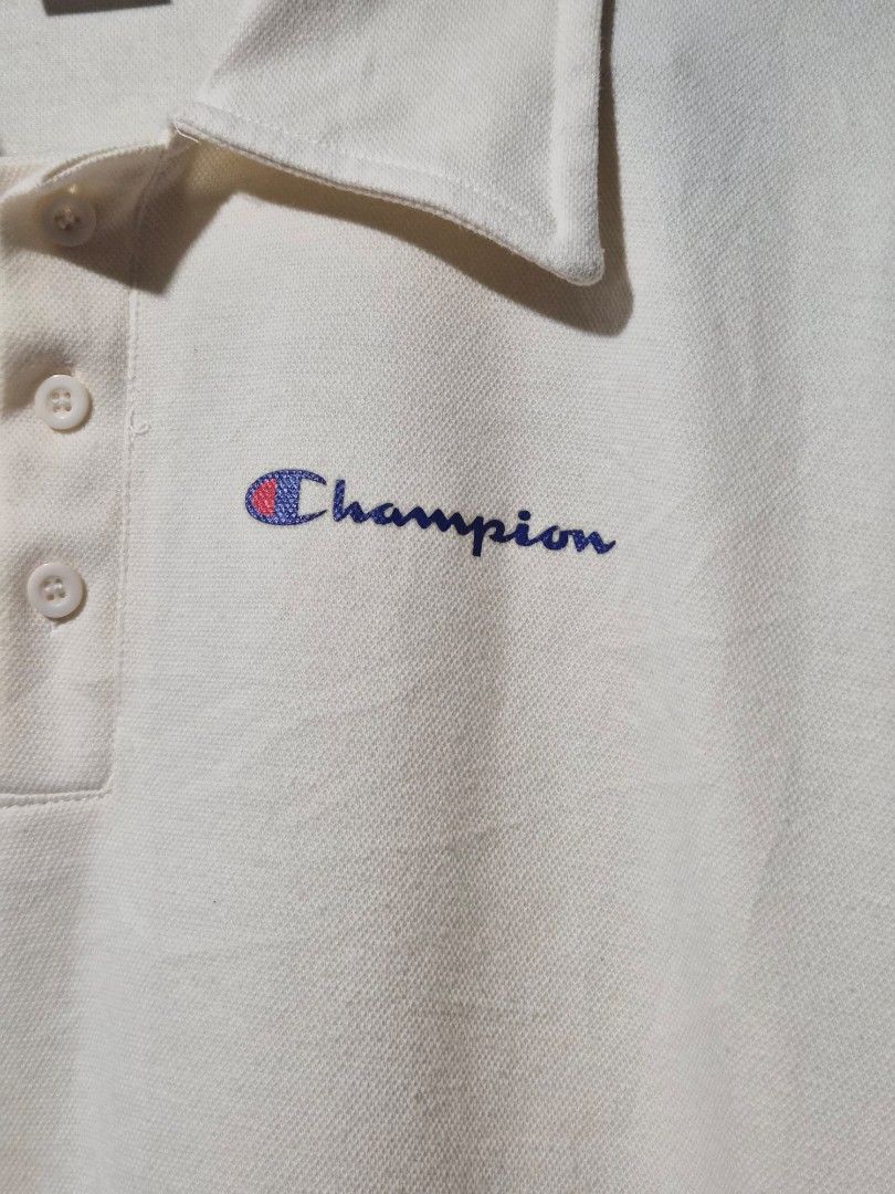 Champion Polo Shirt Oversized (Category: Tshirts & Polo Shirts ) located in Mandaue City. Submitted by chuchi152615 (Listing ID 1438683890, Image 2). Description: - Cream-colored Champion polo shirt - Features the Champion logo - Short sleeves - Collared neckline with 3 buttons - Measurements: 17 inches length, 22 inches width - Made of textured fabric.