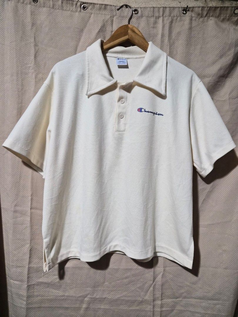 Champion Polo Shirt Oversized (Category: Tshirts & Polo Shirts ) located in Mandaue City. Submitted by chuchi152615 (Listing ID 1438683890, Image 1). Description: - Cream-colored Champion polo shirt - Features the Champion logo - Short sleeves - Collared neckline with 3 buttons - Measurements: 17 inches length, 22 inches width - Made of textured fabric.