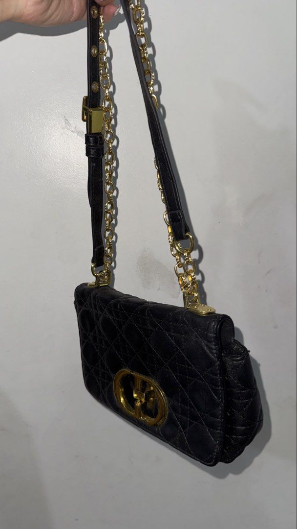 Christian Dior Black Quilted Shoulder Bag (Category: Luxury Bags & Wallets) located in Paranaque City. Submitted by caseycunanan (Listing ID 1438573039, Image 2). Description: - Black quilted shoulder bag - Gold-tone chain strap and hardware - Flap closure with gold-tone CD logo - Interior zippered pocket with Christian Dior label - Made of leather - Adjustable strap.