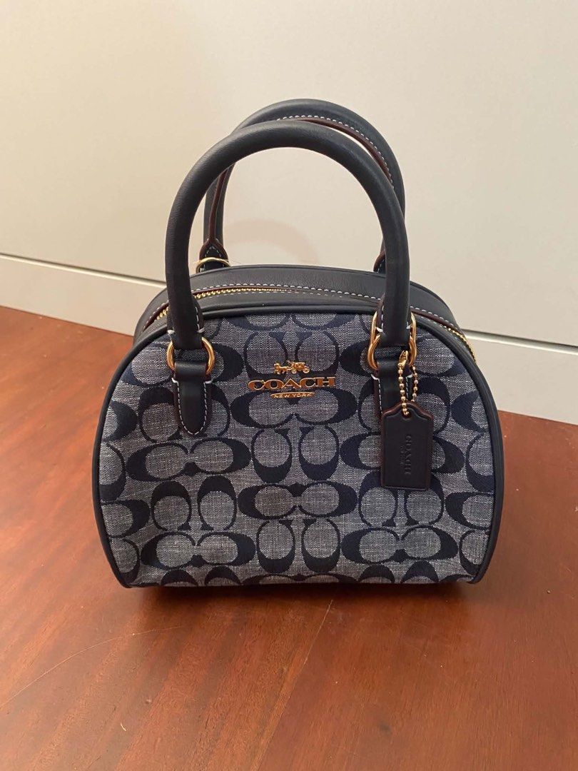 Coach Sydney Satchel Authentic (Category: Luxury Bags & Wallets) located in Rizal. Submitted by mj_arce (Listing ID 1438563197, Image 1). Description: - Coach Sydney Satchel - Signature pattern design - Top handle and detachable strap for shoulder/crossbody wear - Secure zip closure - Interior pocket for essentials - Includes Coach tag and care instructions SF c/o buyer (pick up BGC, Taguig or Alabang).