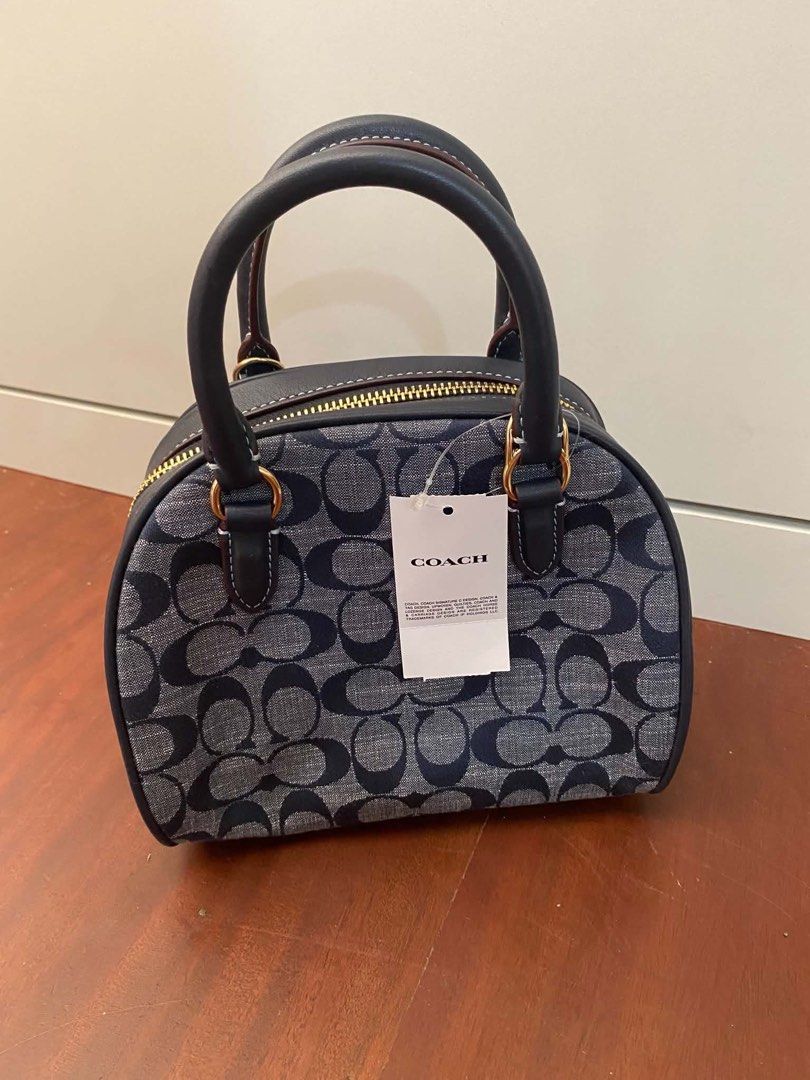 Coach Sydney Satchel Authentic (Category: Luxury Bags & Wallets) located in Rizal. Submitted by mj_arce (Listing ID 1438563197, Image 2). Description: - Coach Sydney Satchel - Signature pattern design - Top handle and detachable strap for shoulder/crossbody wear - Secure zip closure - Interior pocket for essentials - Includes Coach tag and care instructions SF c/o buyer (pick up BGC, Taguig or Alabang).